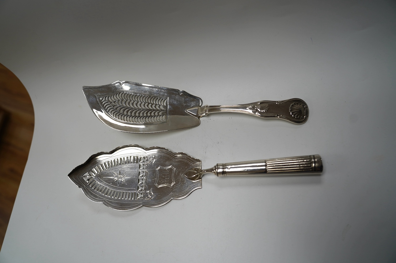 A George III silver fish slice with part gallery border, Henry Chawner, London, 1791, 30.4cm and a later George IV silver King's pattern fish slice, London, 1821. Condition - poor to fair